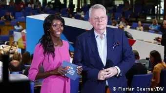Presenter Liz Shoo is seen with DW Director General Peter Limbourg during the 2023 edition of the DW Global Media Forum